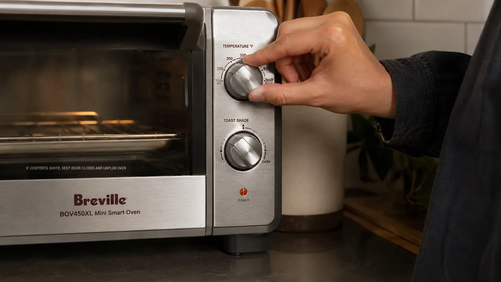 Close-up of the Breville BOV450XL control panel showing the toast shade dial and cooking function selector knobs